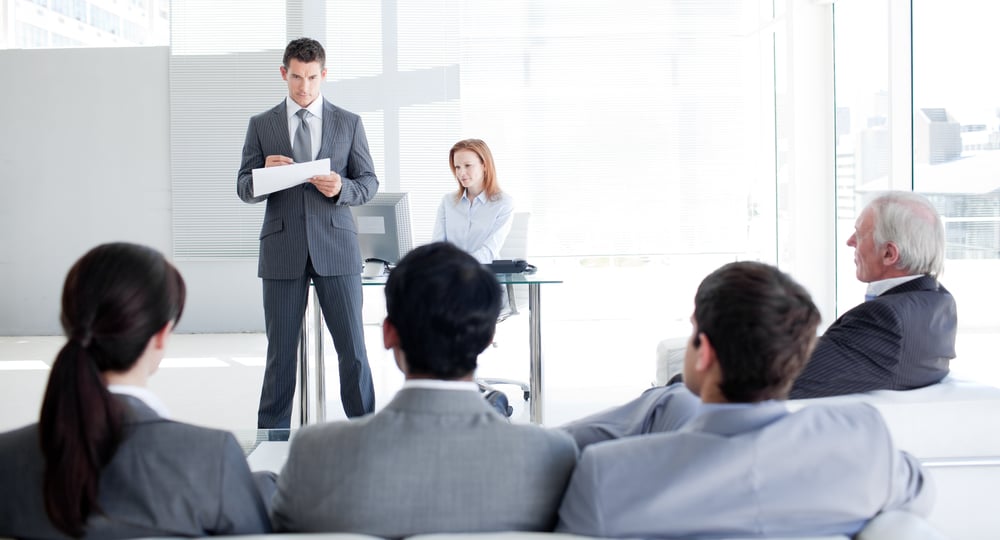 A team leader talking to his colleagues in an office