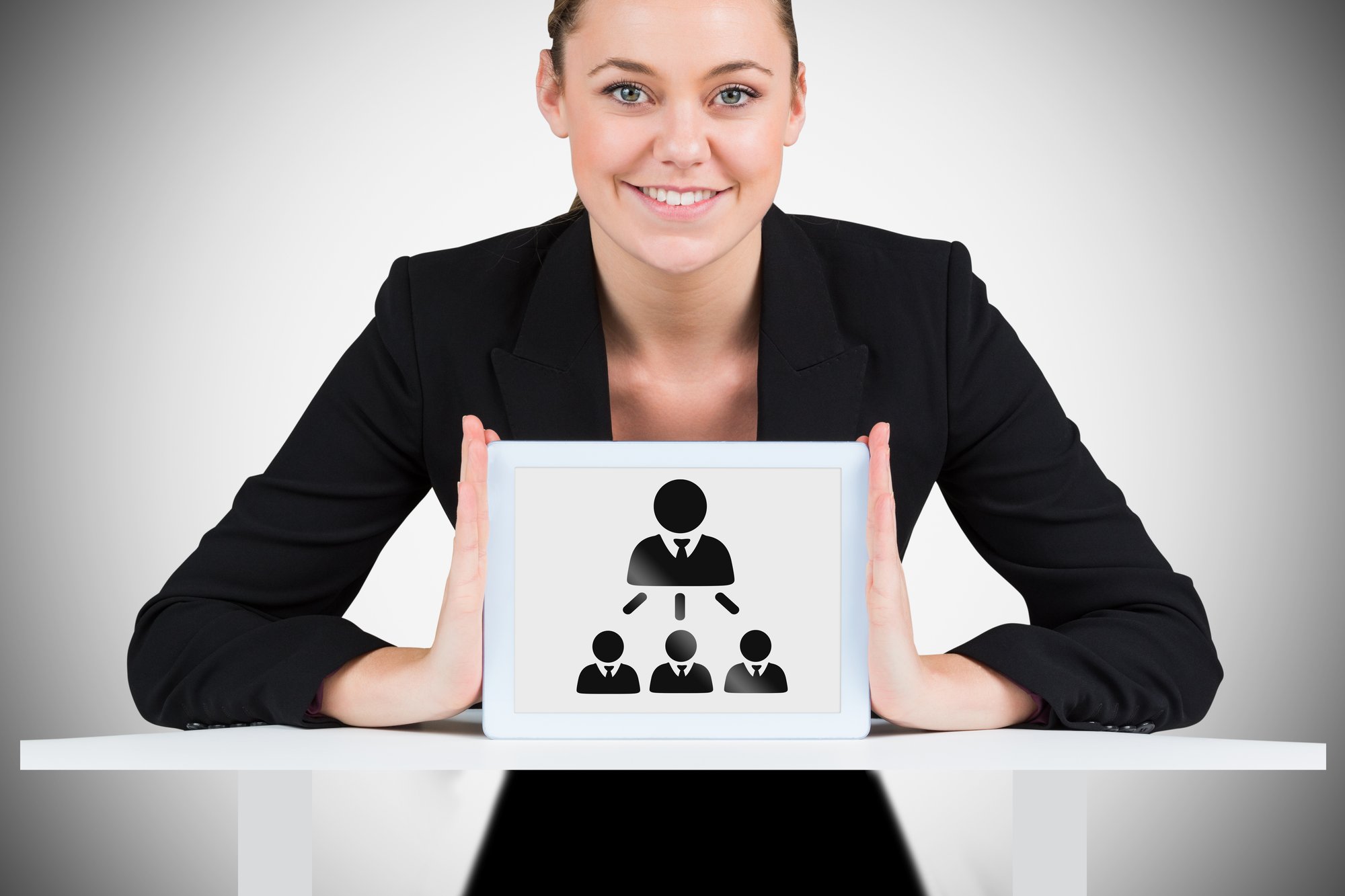 businesswoman-showing-tablet-pc-against-white-background-with-vignette