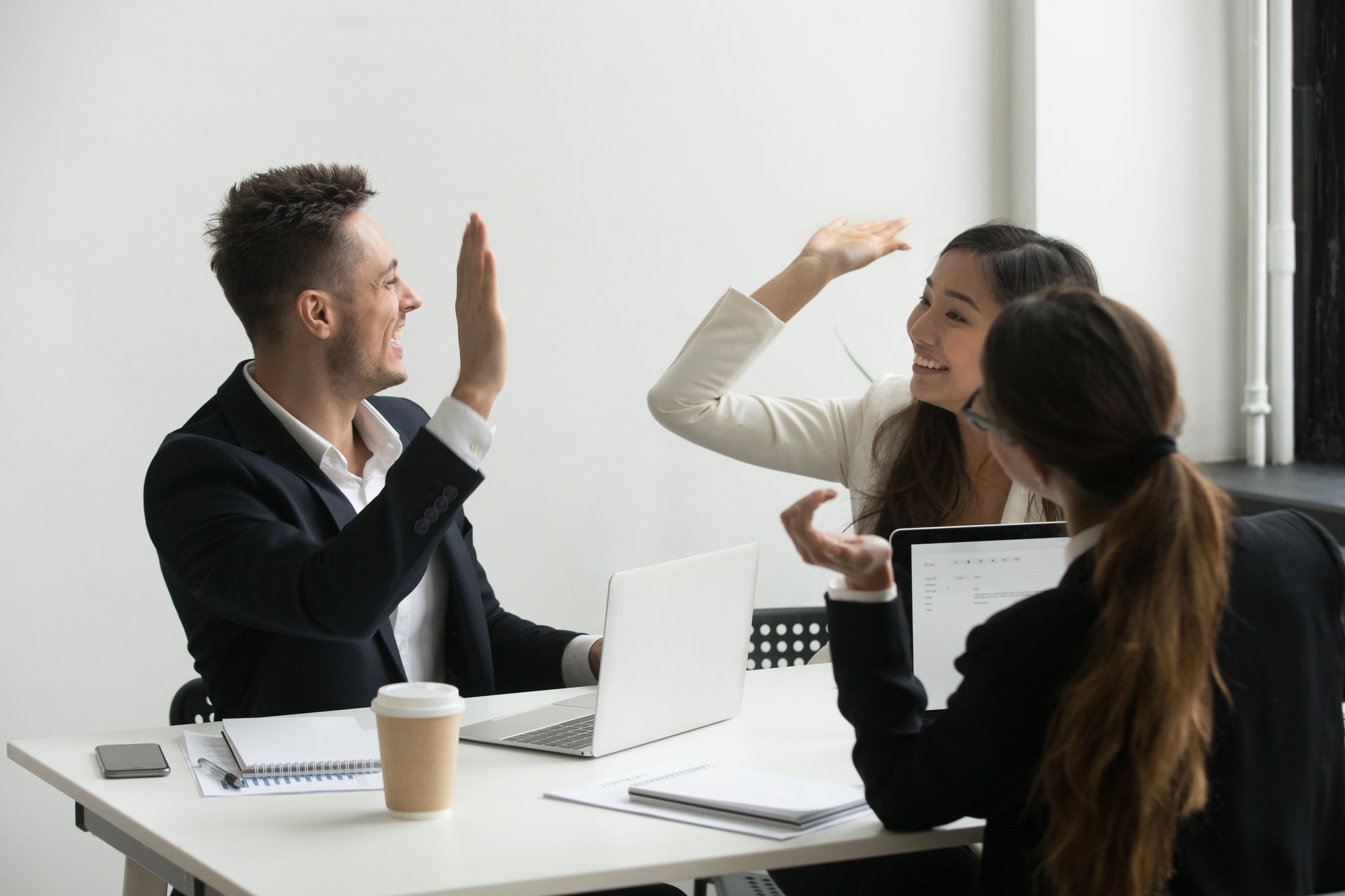 colleagues-giving-high-five-celebrating-shared-success