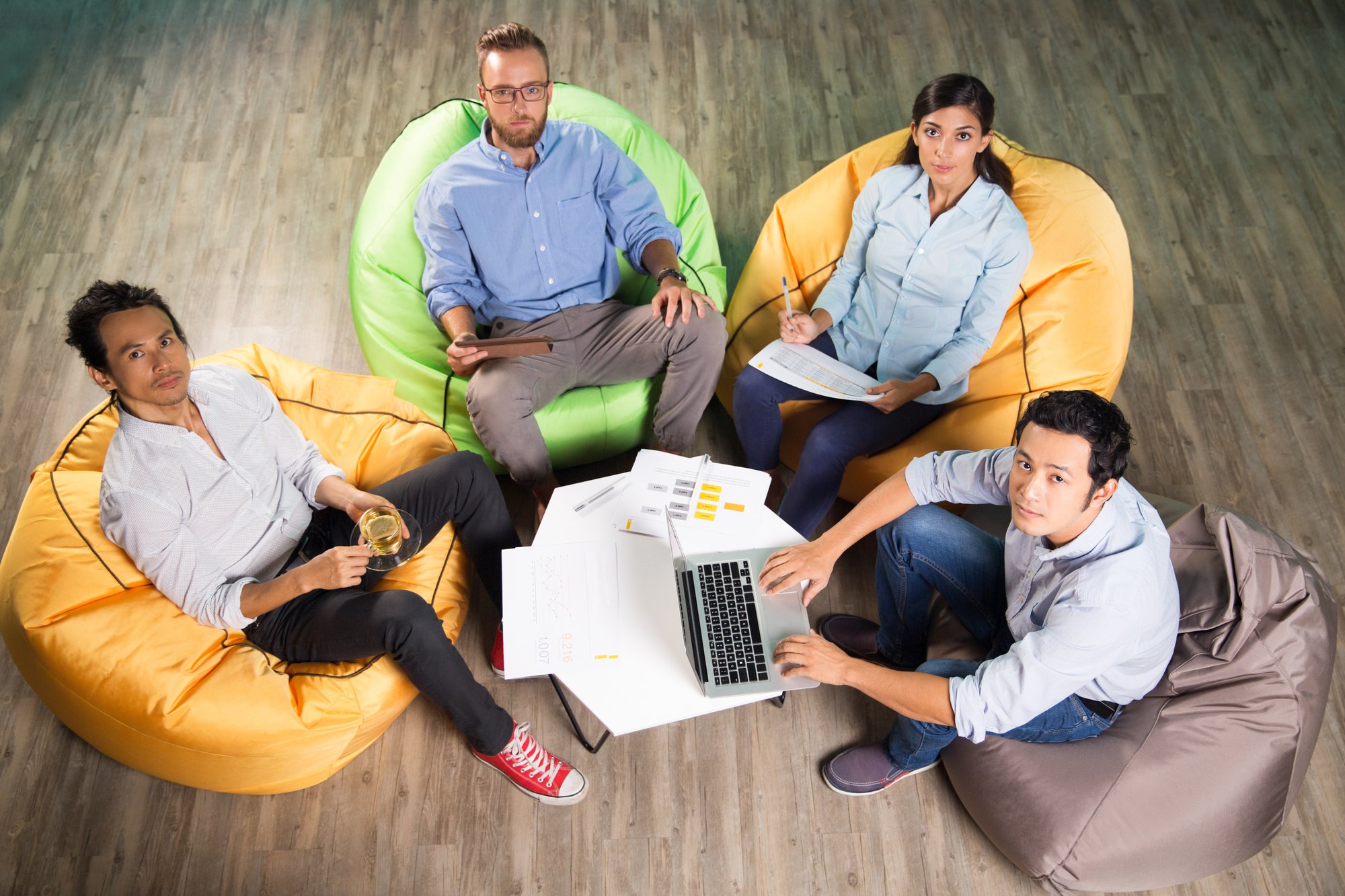 four-people-working-sitting-beanbag-chairs