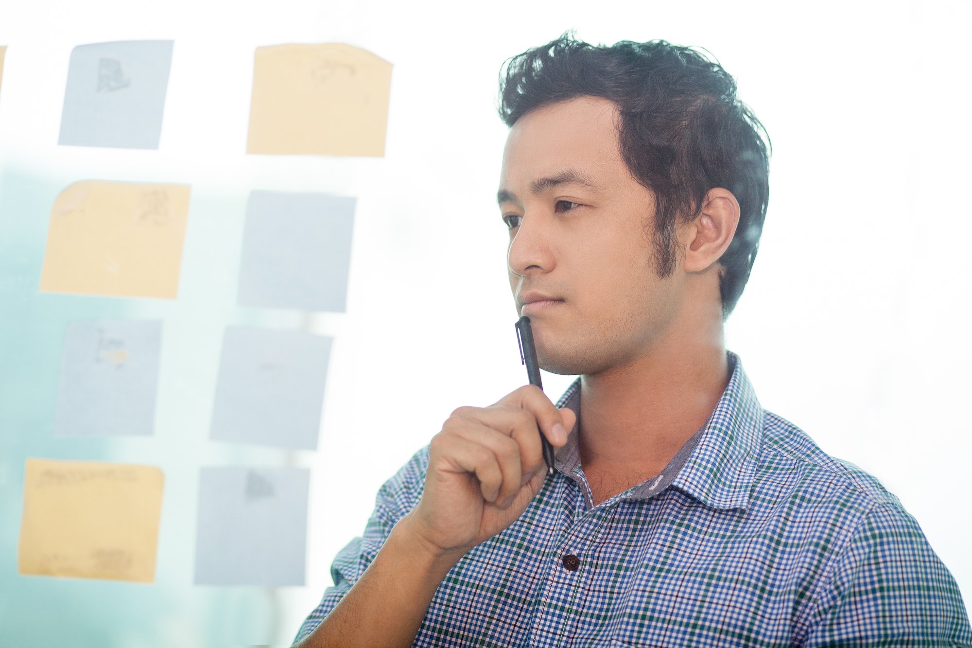 thoughtful-young-asian-business-man-planning-work