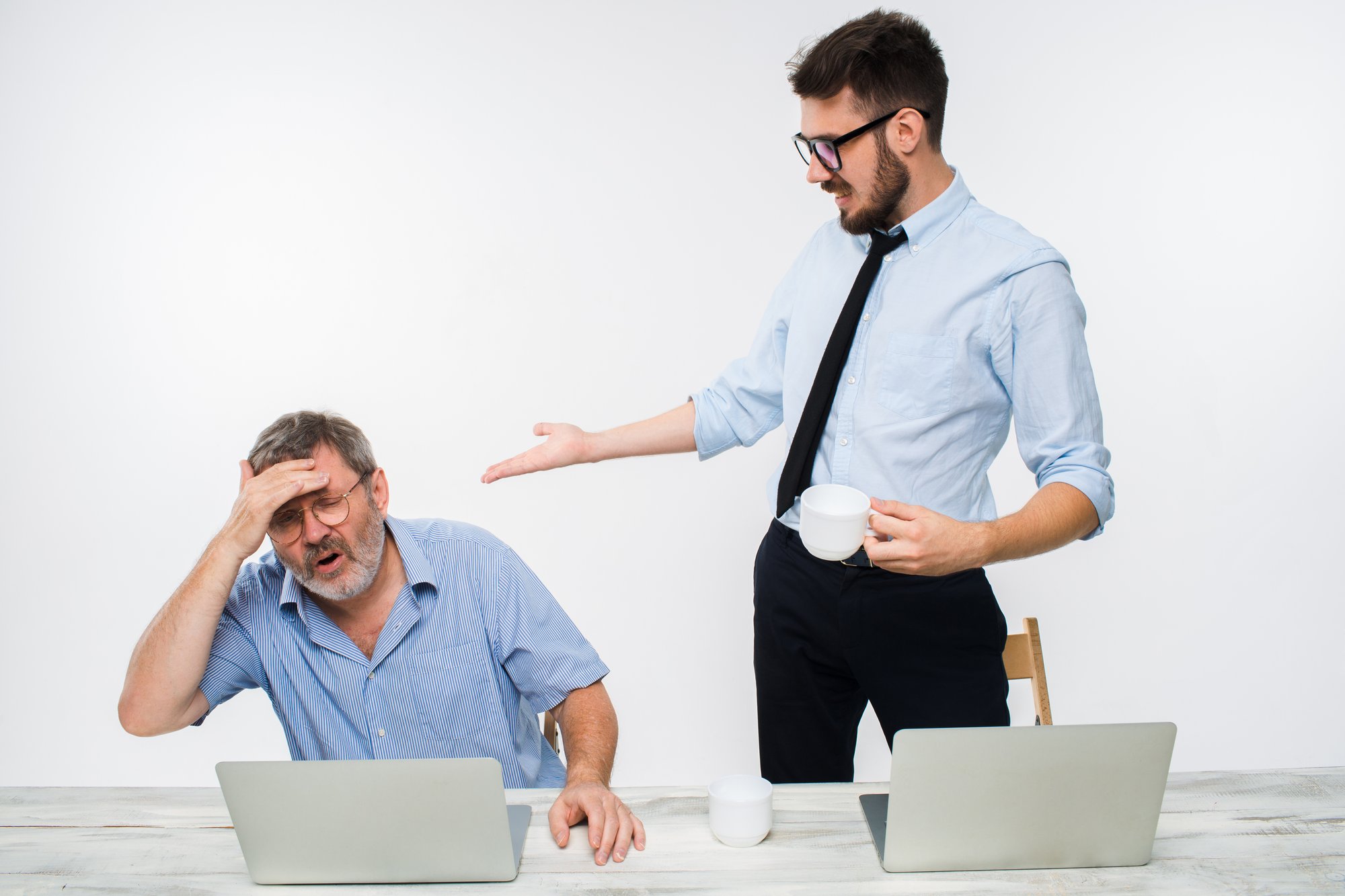 two-colleagues-working-together-office-white-background
